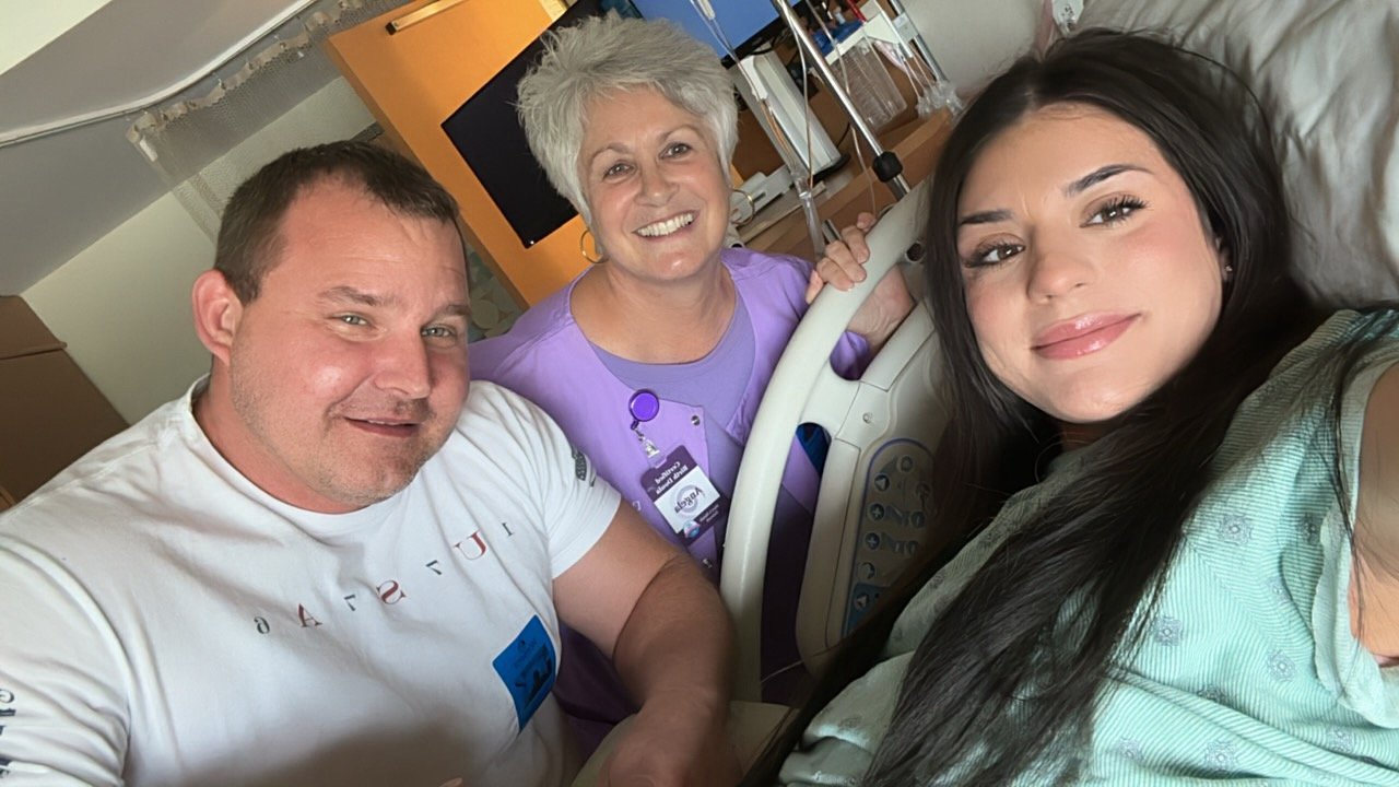 MHN doula GiGi at the bedside with a young family and their newborn