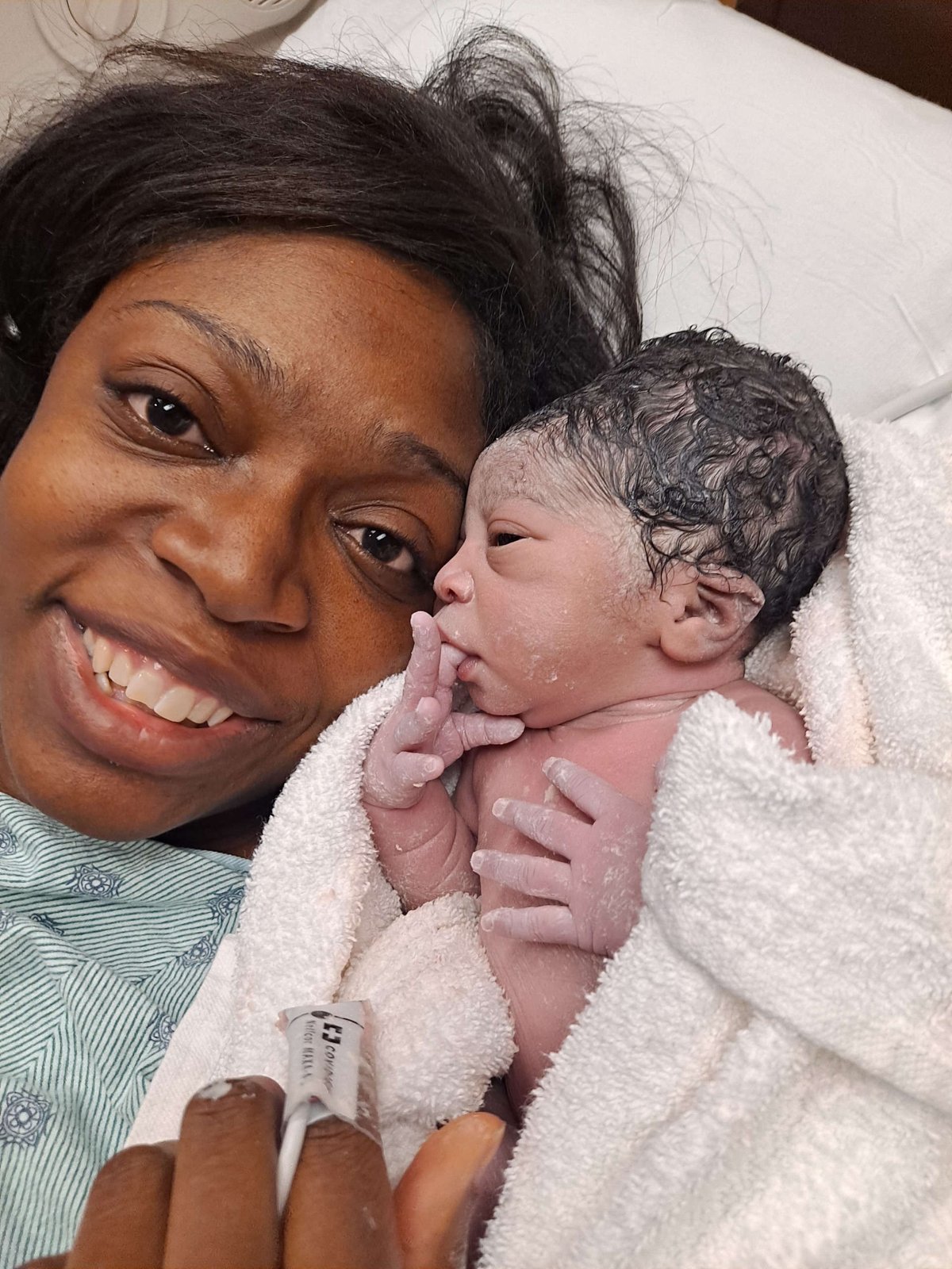A new mother smiling with her newborn