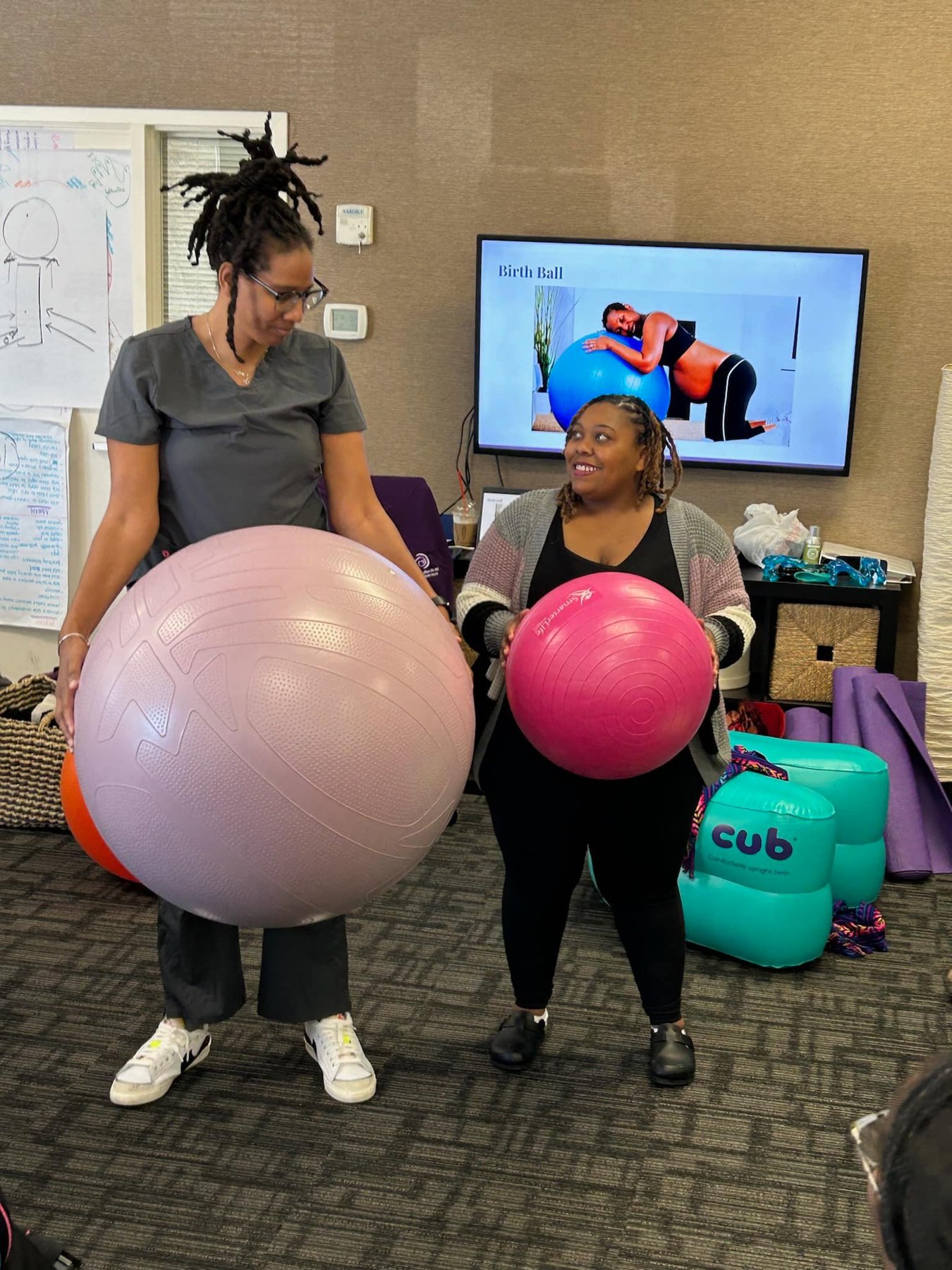 Trainees comparing birth ball sizes during hands-on practice