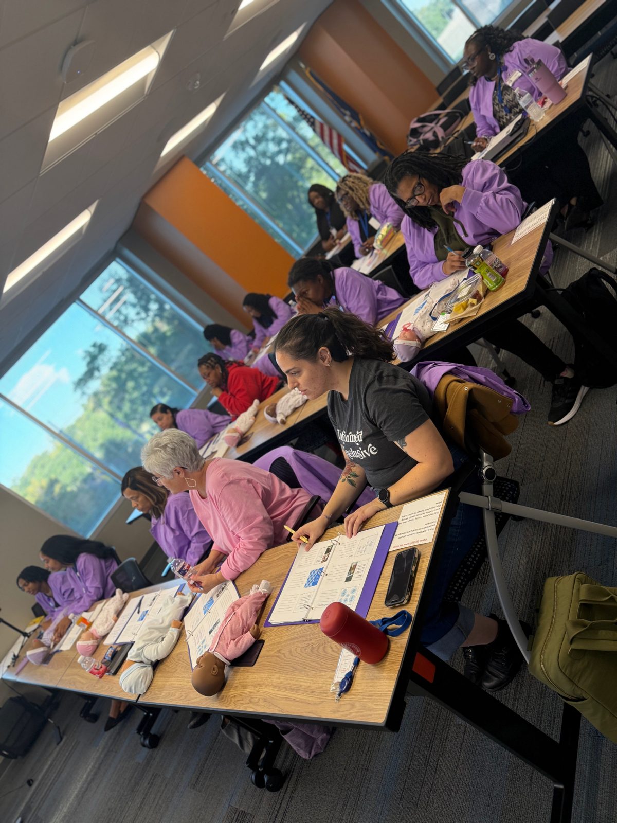 Cohort working through pre-work at long tables