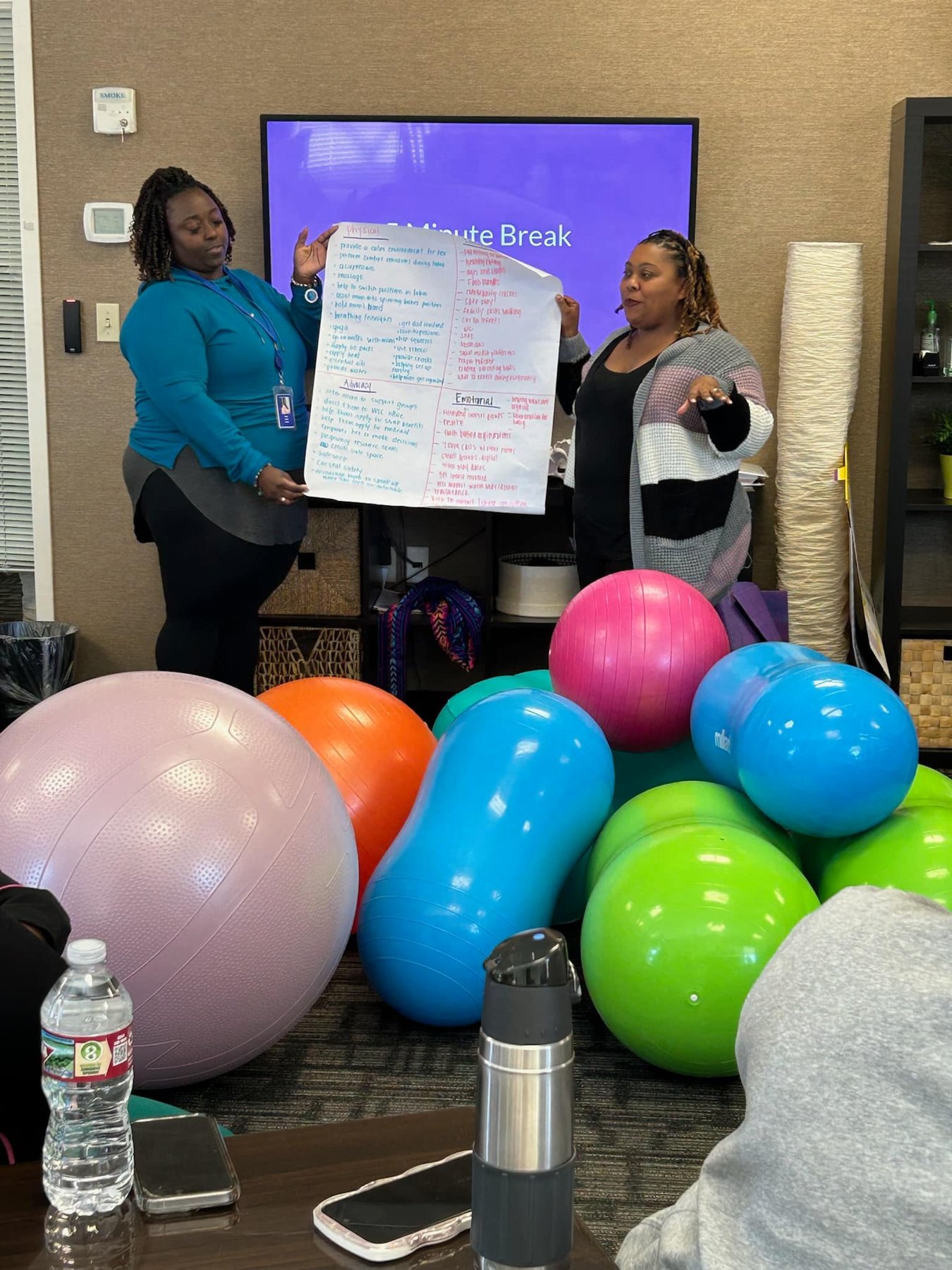 Two MHN doulas presenting comfort-measure chart