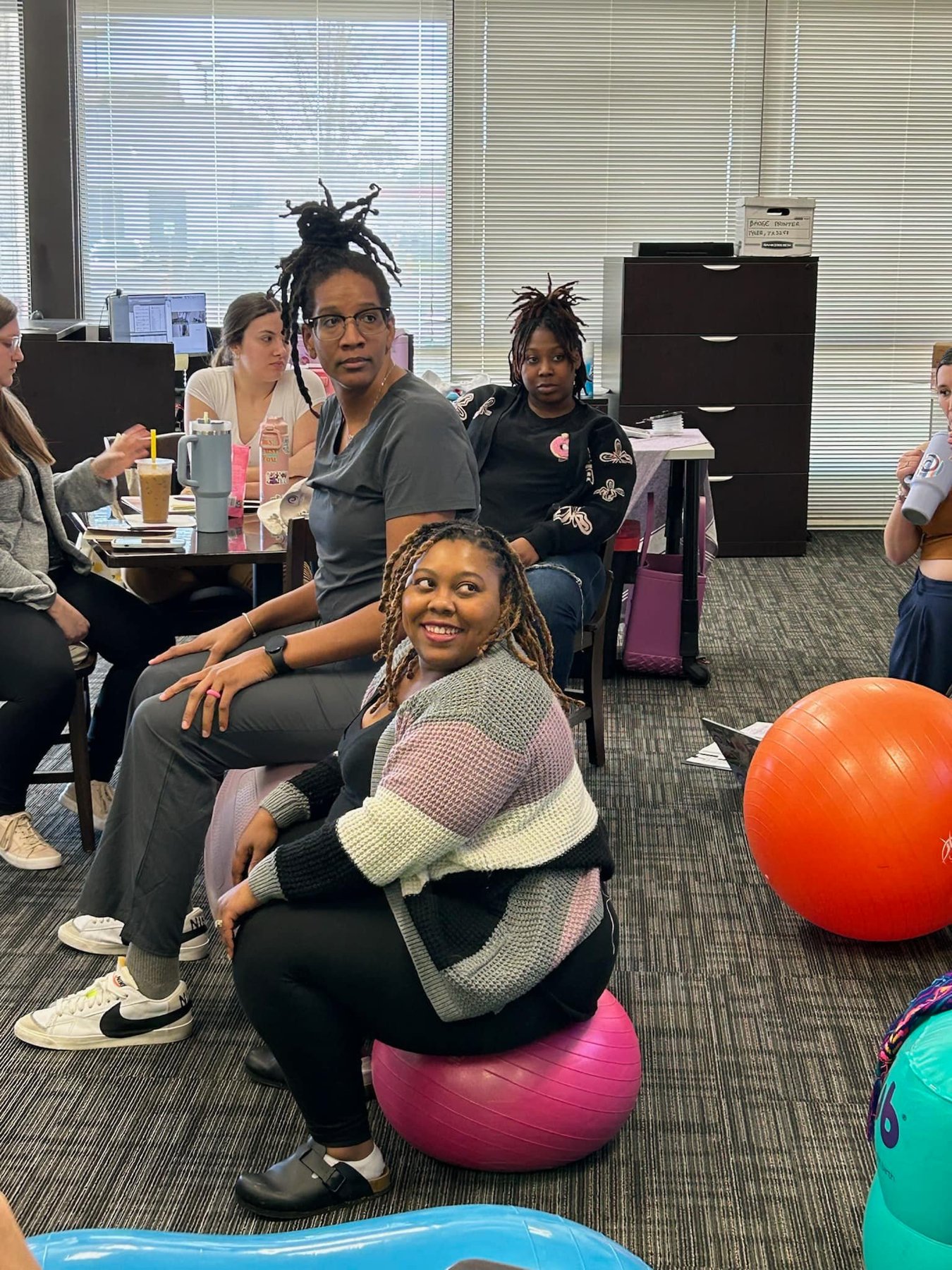 Trainees seated on birth balls in classroom